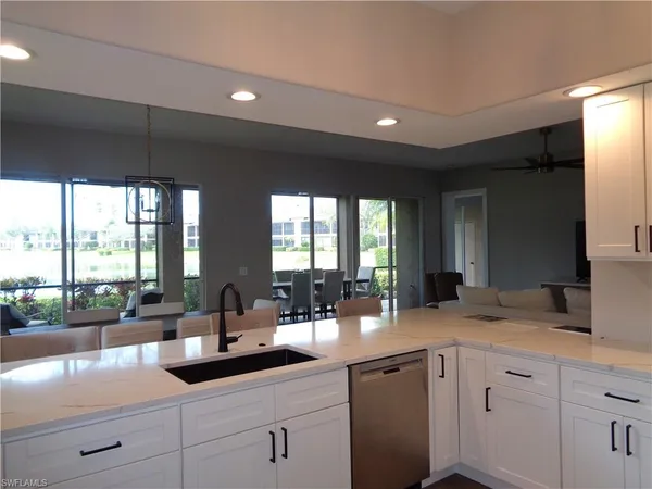 a kitchen with sink and view living room