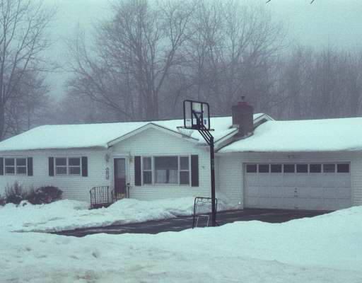 a yellow and red house with a yard