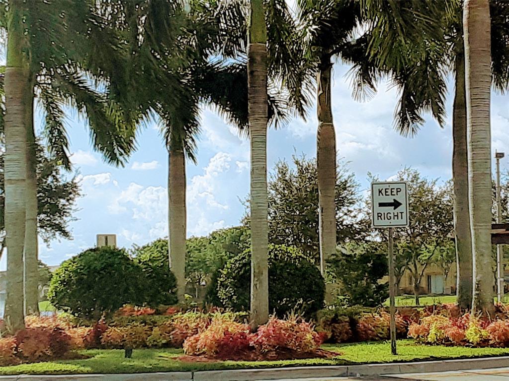 1425 Southeast 24th Court Homestead, FL 33035 - Photo 2 of 29 a front view of multi story residential apartment building with yard and green space