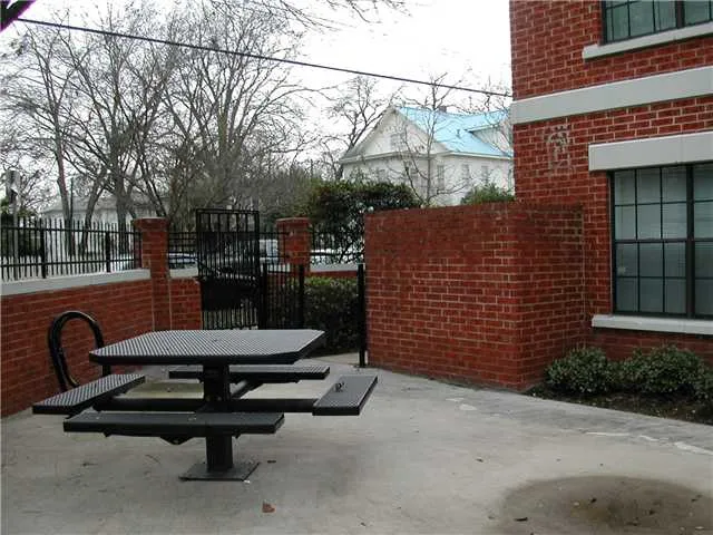 a view of a patio with a table and chairs