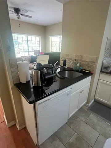 a kitchen with a sink and cabinets