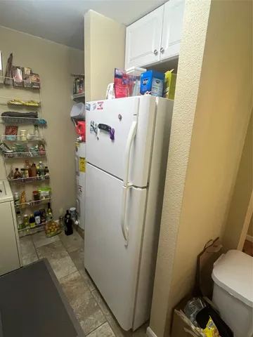 a white refrigerator freezer sitting next to a sink