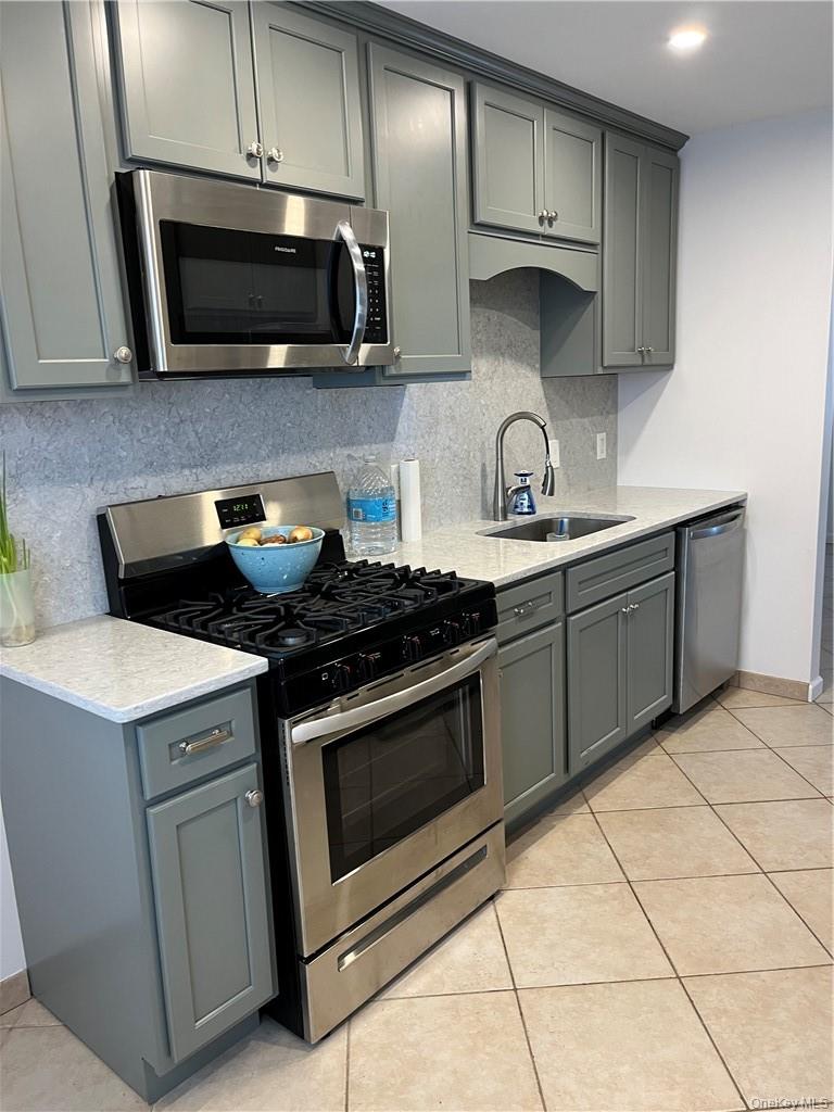 2905 Fox Lane Poughkeepsie, NY 12603 - Photo 3 of 21 a kitchen with stainless steel appliances granite countertop a stove microwave and sink