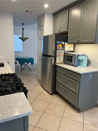 a kitchen with stainless steel appliances granite countertop a refrigerator and a stove