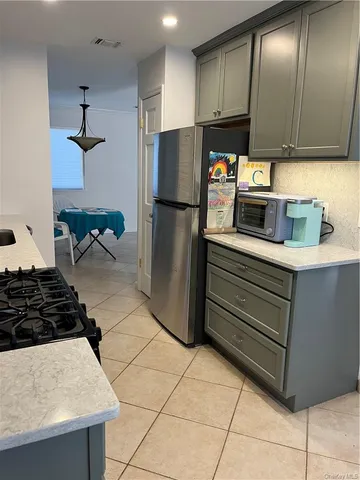 a kitchen with stainless steel appliances granite countertop a refrigerator and a stove