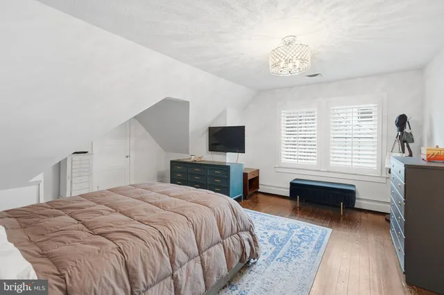 a kitchen with a stove and a wooden floor