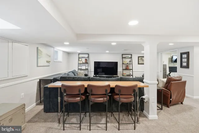 a view of a patio with couches table and chairs with wooden floor and fence