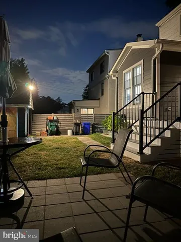 a view of a building with a couple of cars parked on the road
