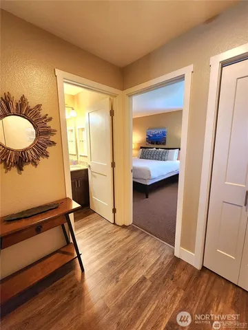 a bedroom with a bed and tv on the dresser