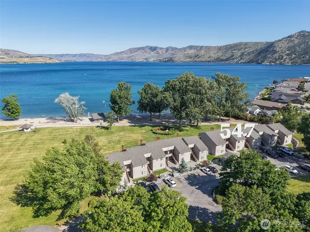 a dining room with furniture a chandelier and wooden floor