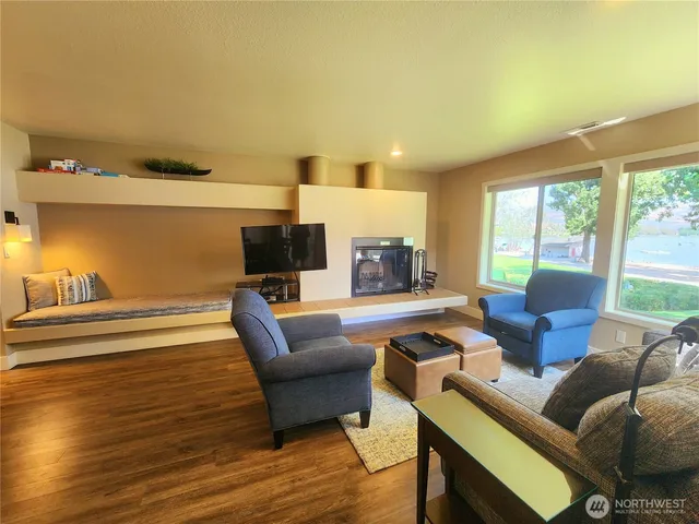 a living room with furniture dining table and a large window