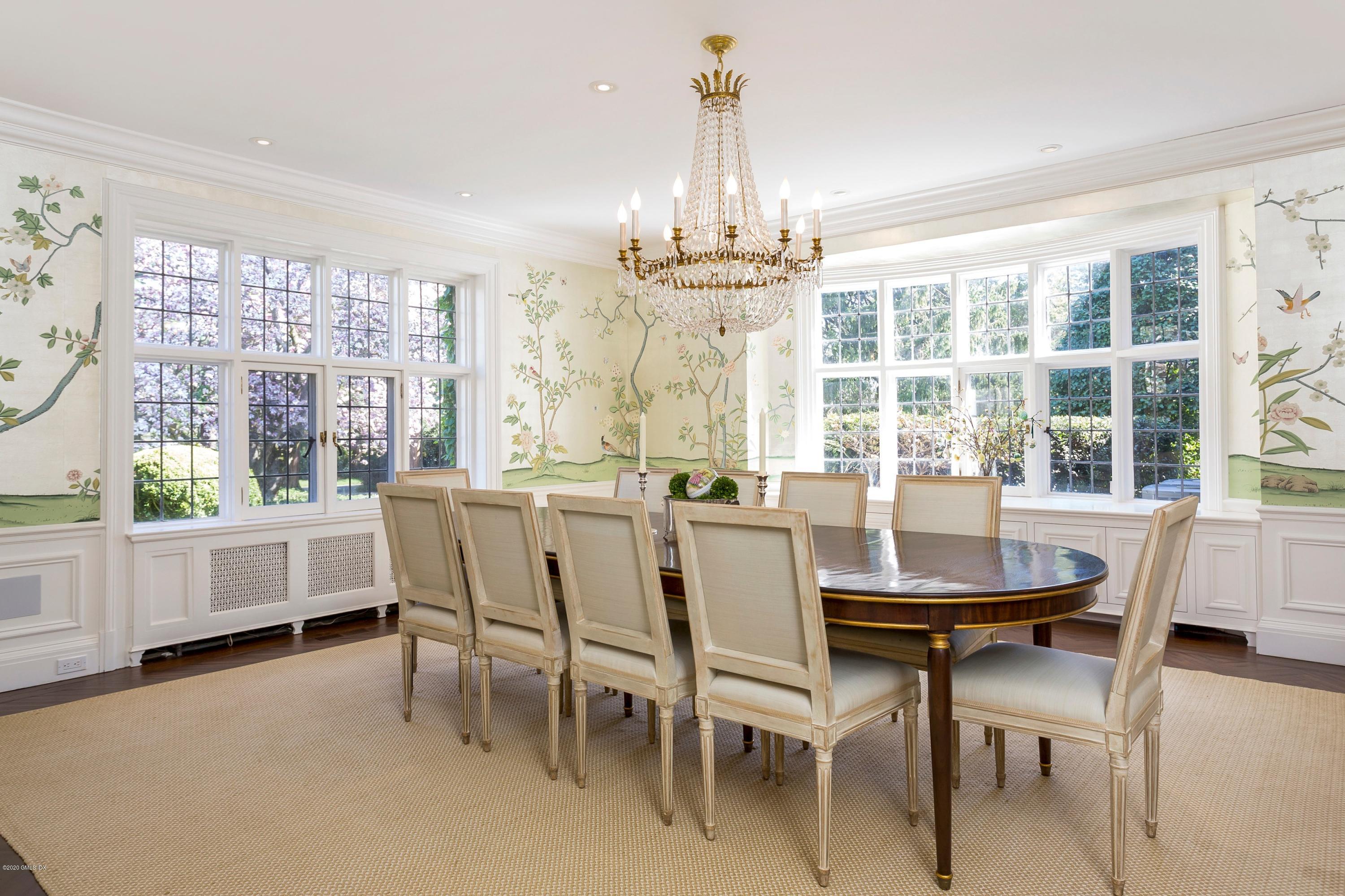 2 Broad Road Greenwich, CT 06830 - Photo 11 of 39 a dining room with furniture large windows and a chandelier