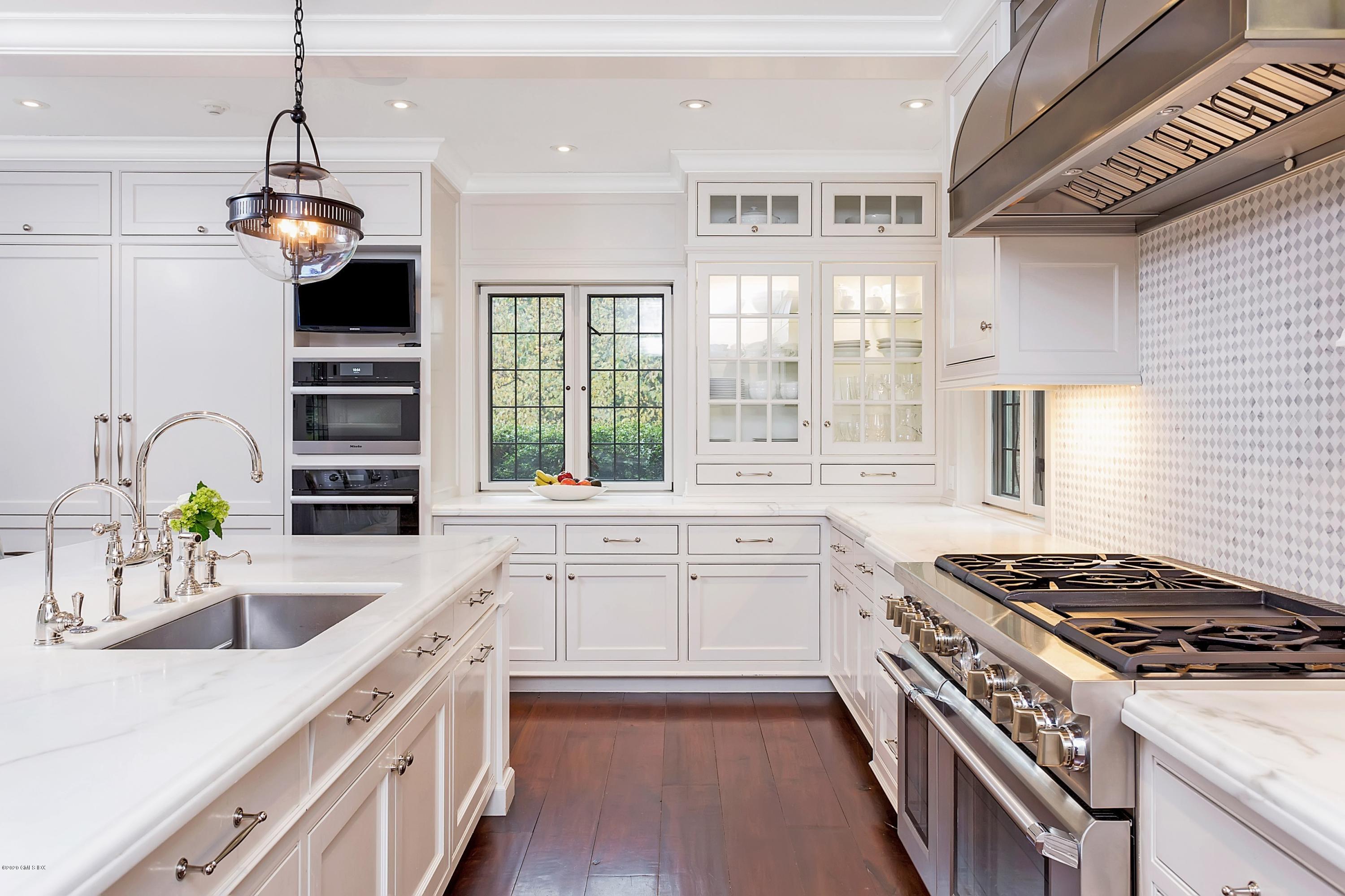 2 Broad Road Greenwich, CT 06830 - Photo 14 of 39 a kitchen with a stove a sink and a refrigerator