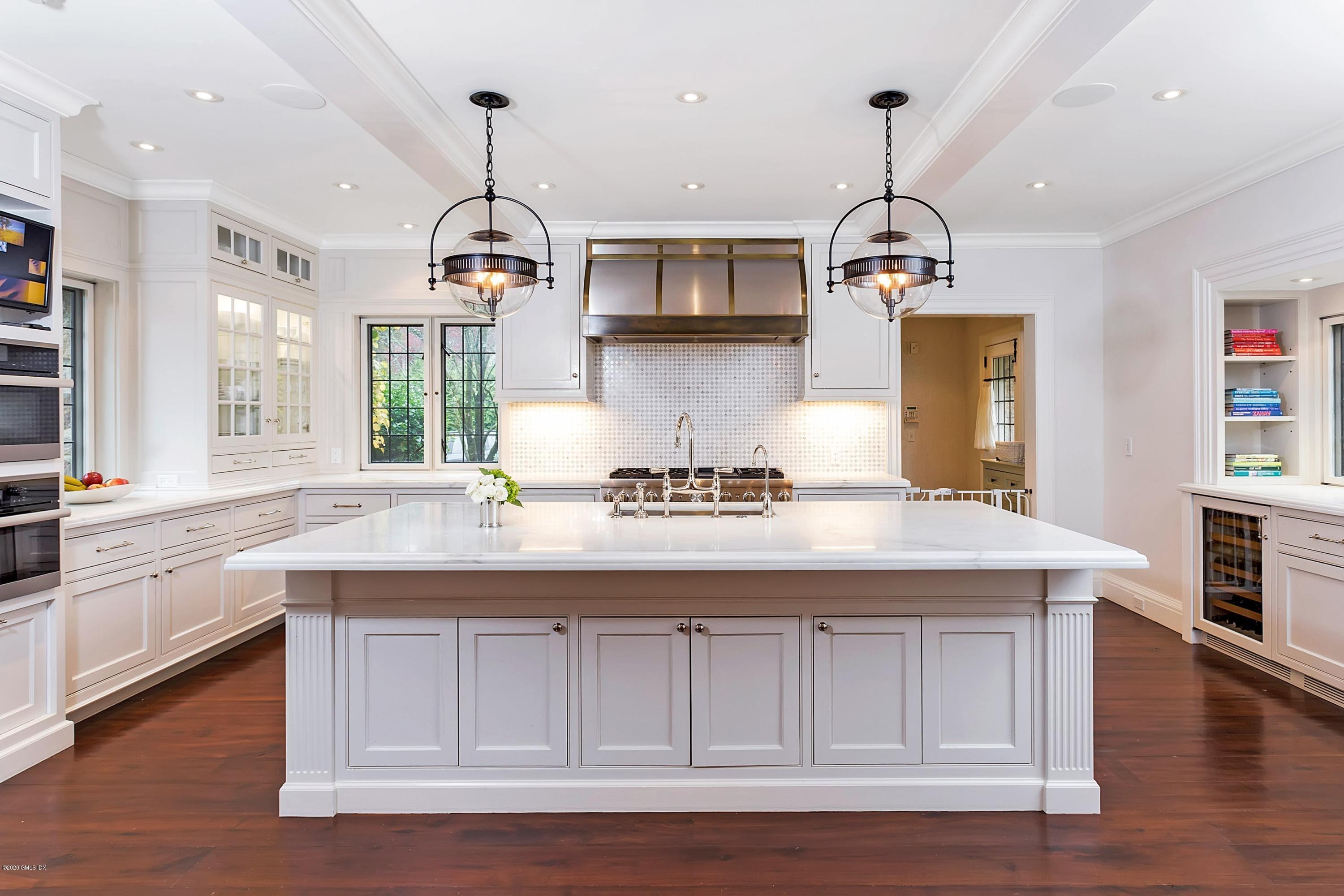 2 Broad Road Greenwich, CT 06830 - Photo 15 of 39 a kitchen with a sink a center island cabinets and wooden floor