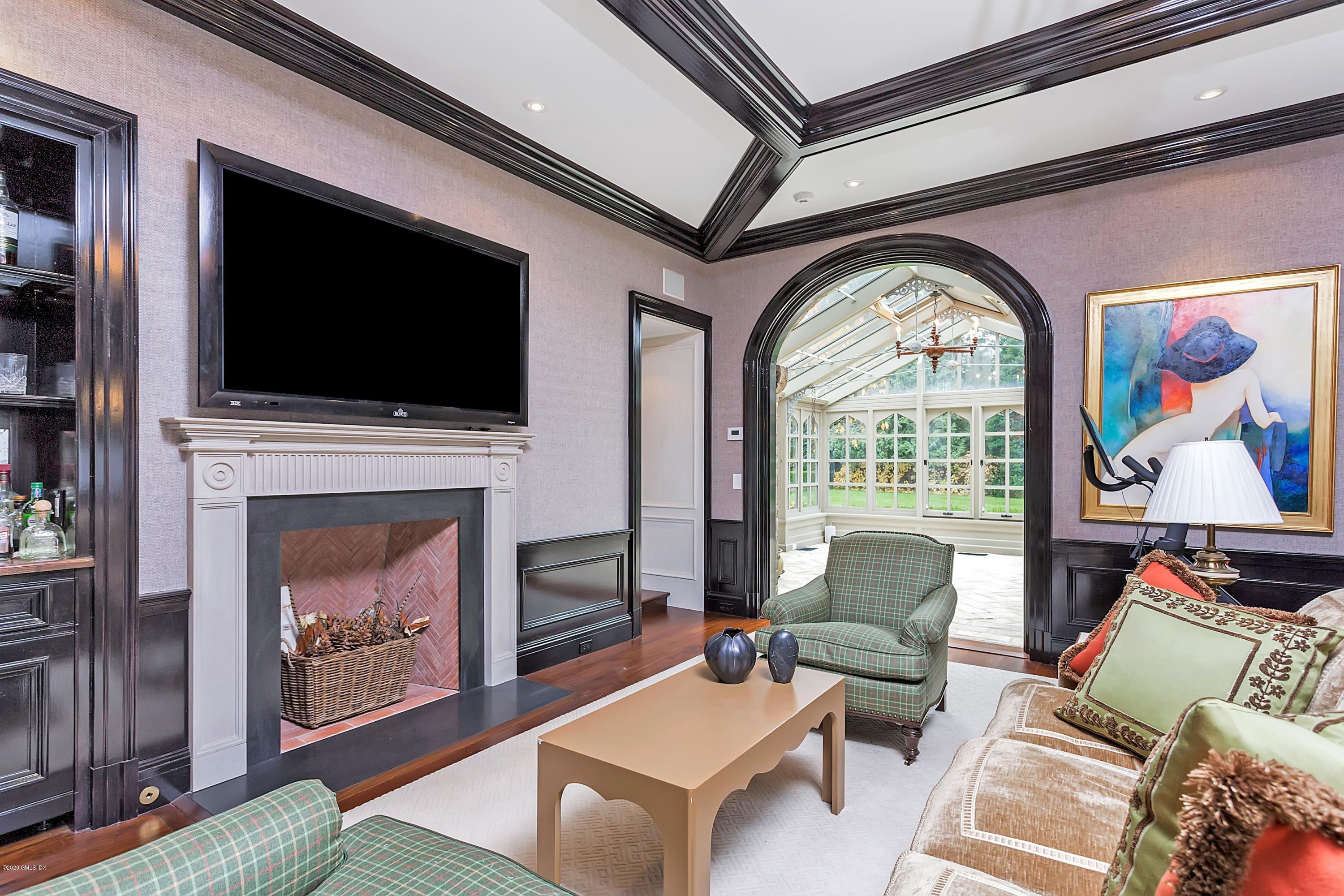 2 Broad Road Greenwich, CT 06830 - Photo 22 of 39 a living room with furniture a fireplace and a flat screen tv