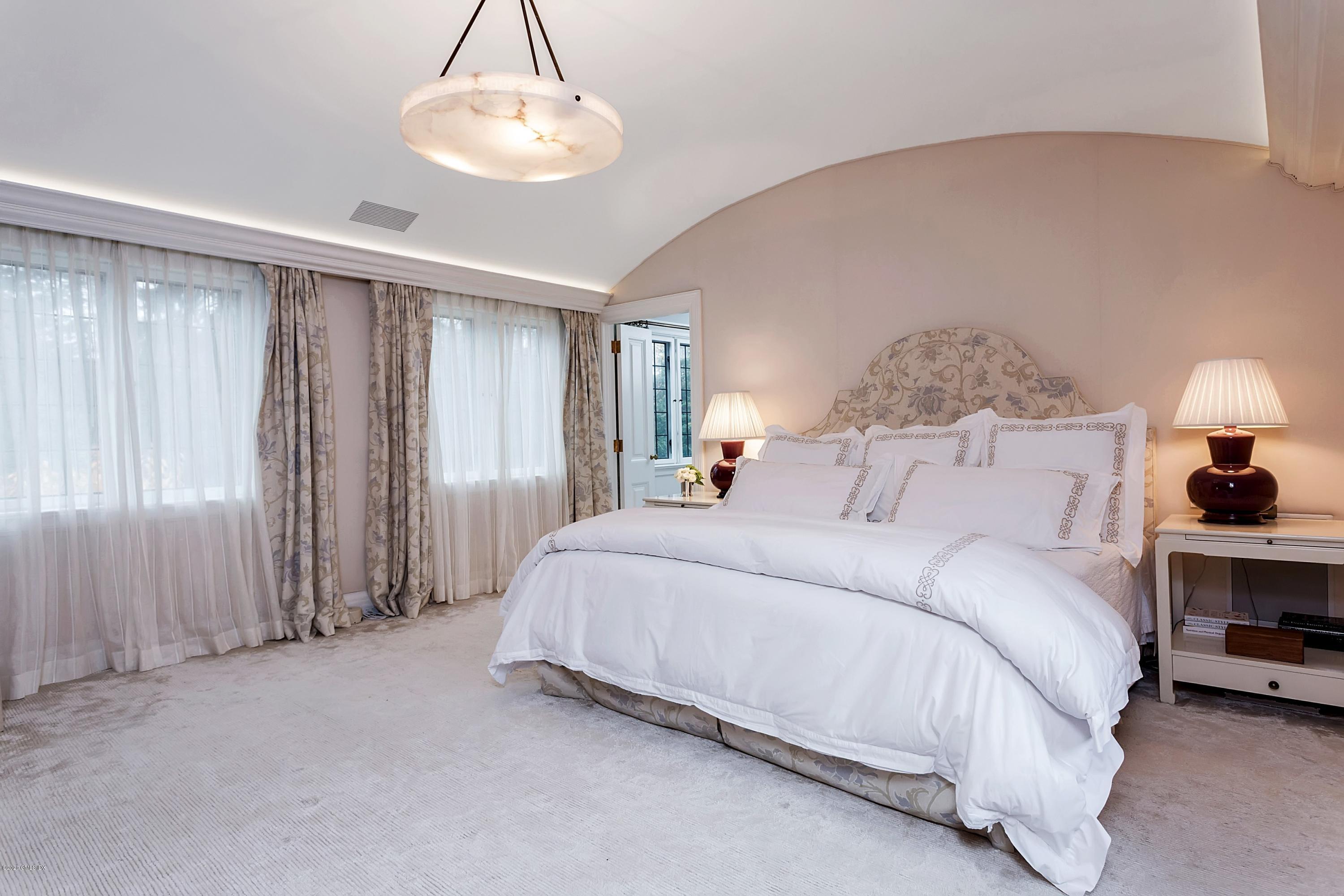 2 Broad Road Greenwich, CT 06830 - Photo 24 of 39 a spacious bedroom with a bed and a lamp