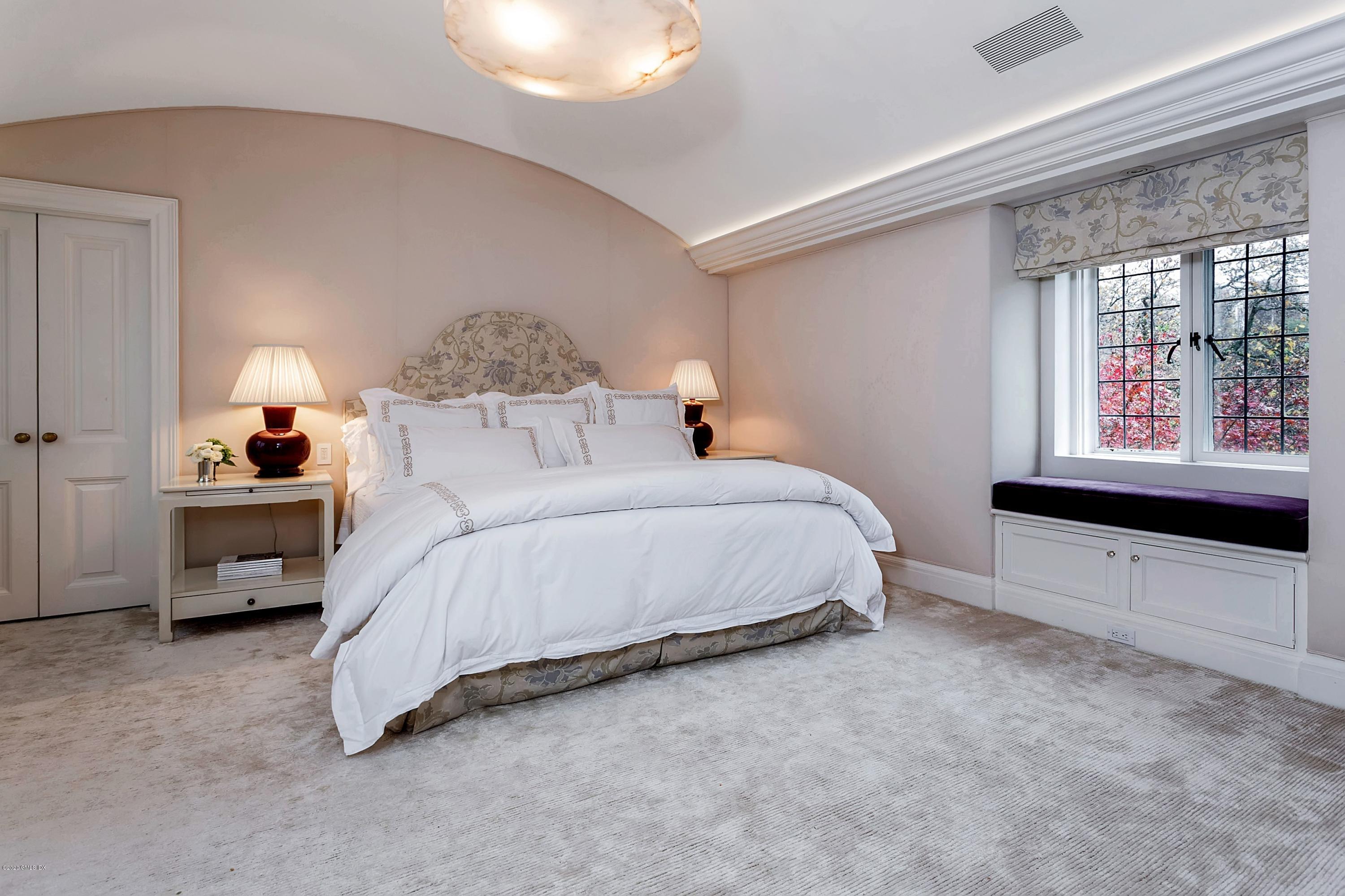 2 Broad Road Greenwich, CT 06830 - Photo 25 of 39 a spacious bedroom with a bed and a window