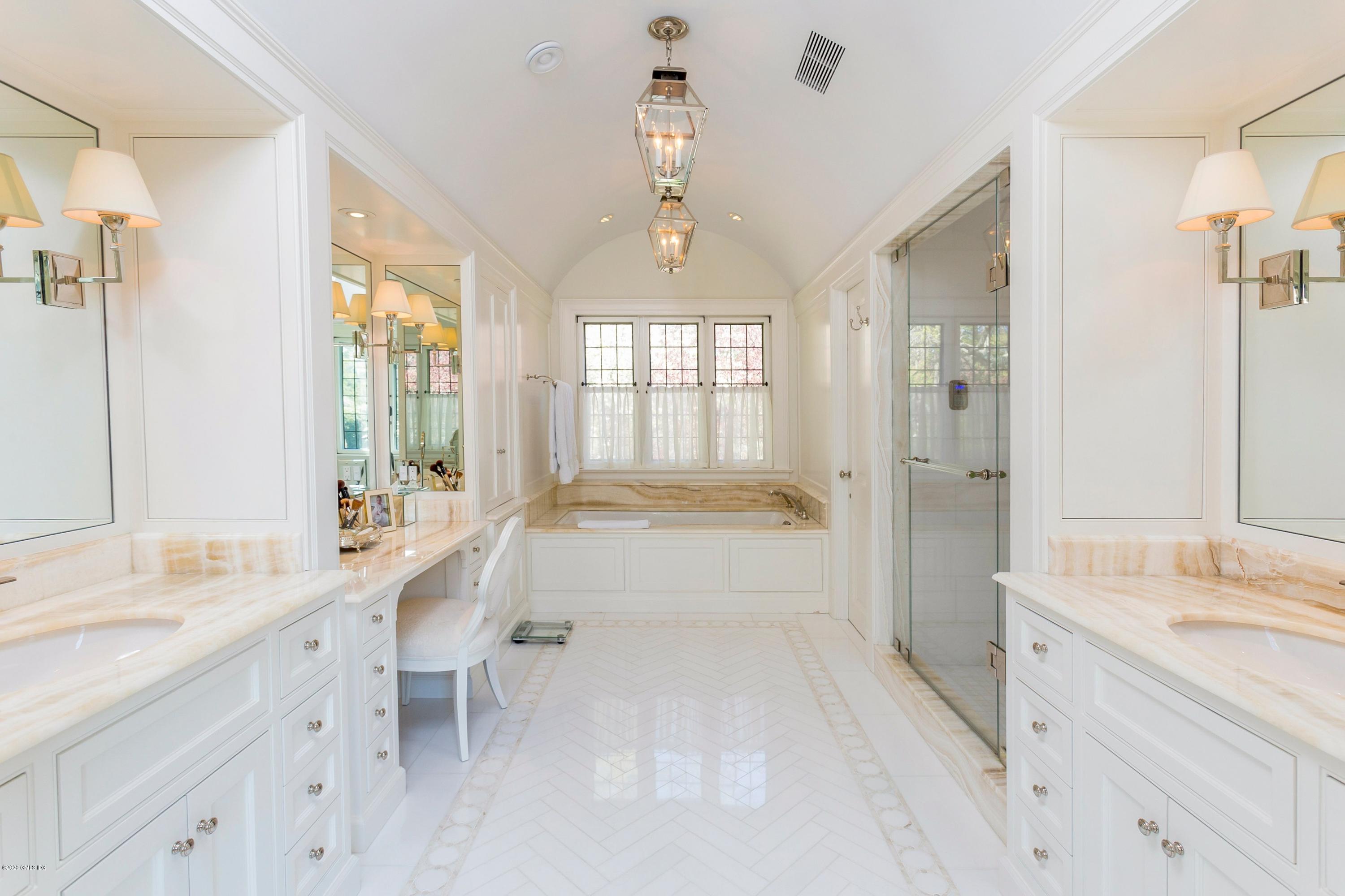 2 Broad Road Greenwich, CT 06830 - Photo 26 of 39 a large white bathroom with a granite countertop double vanity sink a mirror and a bathtub