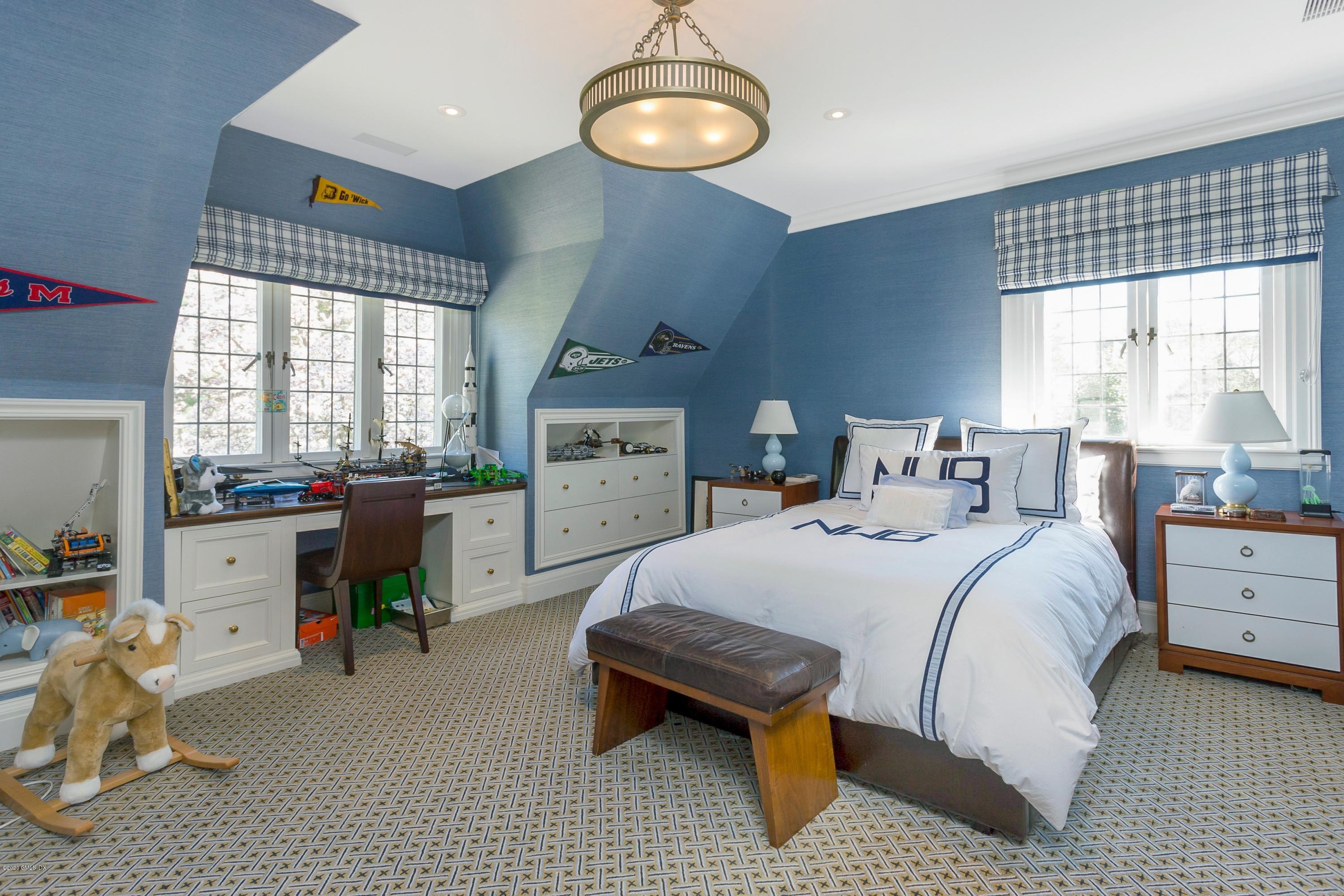2 Broad Road Greenwich, CT 06830 - Photo 29 of 39 a bed room with a bed and a chandelier