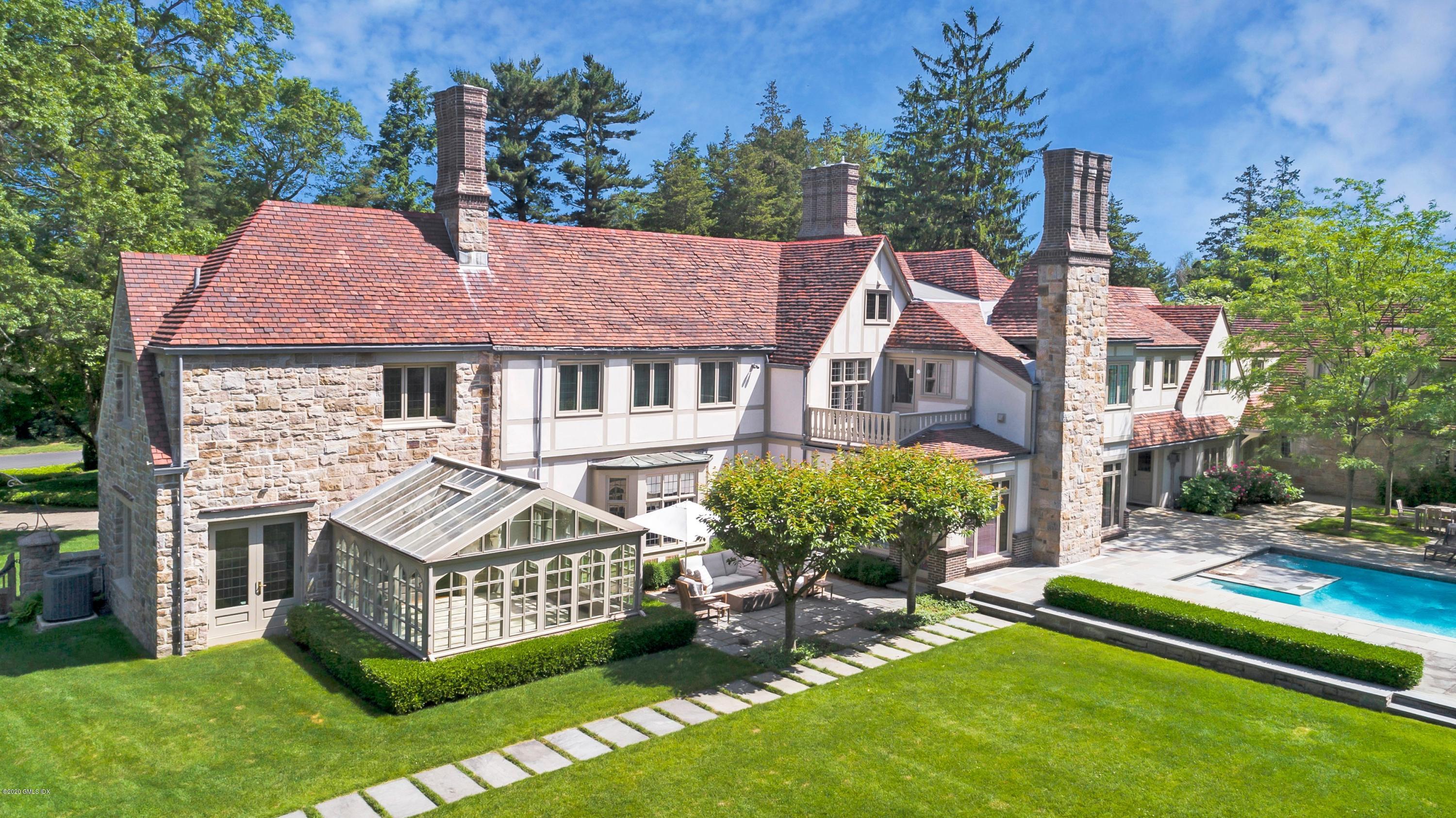 2 Broad Road Greenwich, CT 06830 - Photo 36 of 39 a front view of a house with a garden and plants