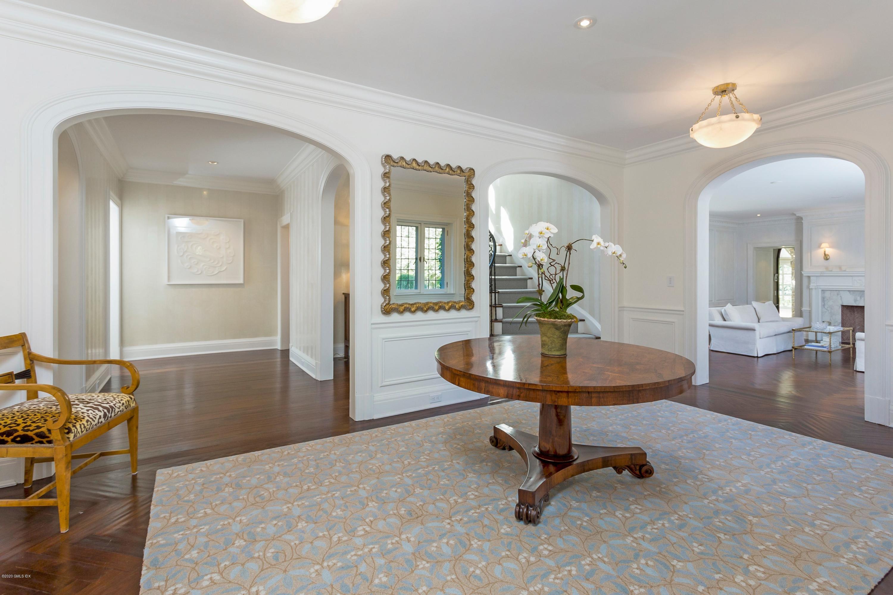 2 Broad Road Greenwich, CT 06830 - Photo 8 of 39 a living room with furniture and a chandelier