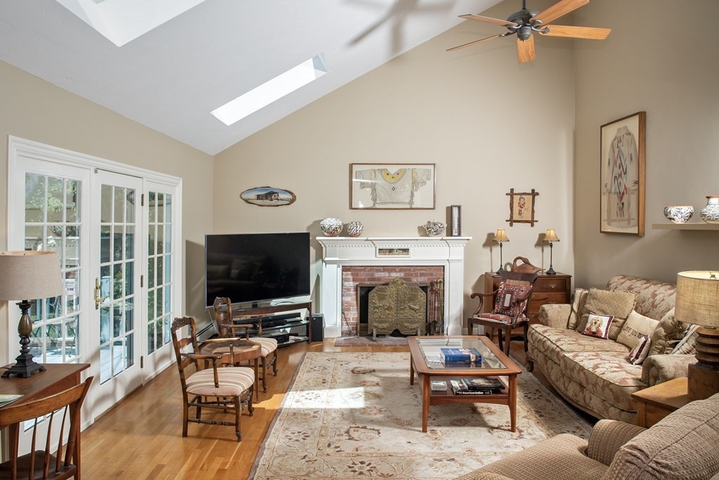 130 Union Bridge Road Duxbury, MA 02332 - Photo 12 of 33 a living room with furniture a fireplace and a flat screen tv
