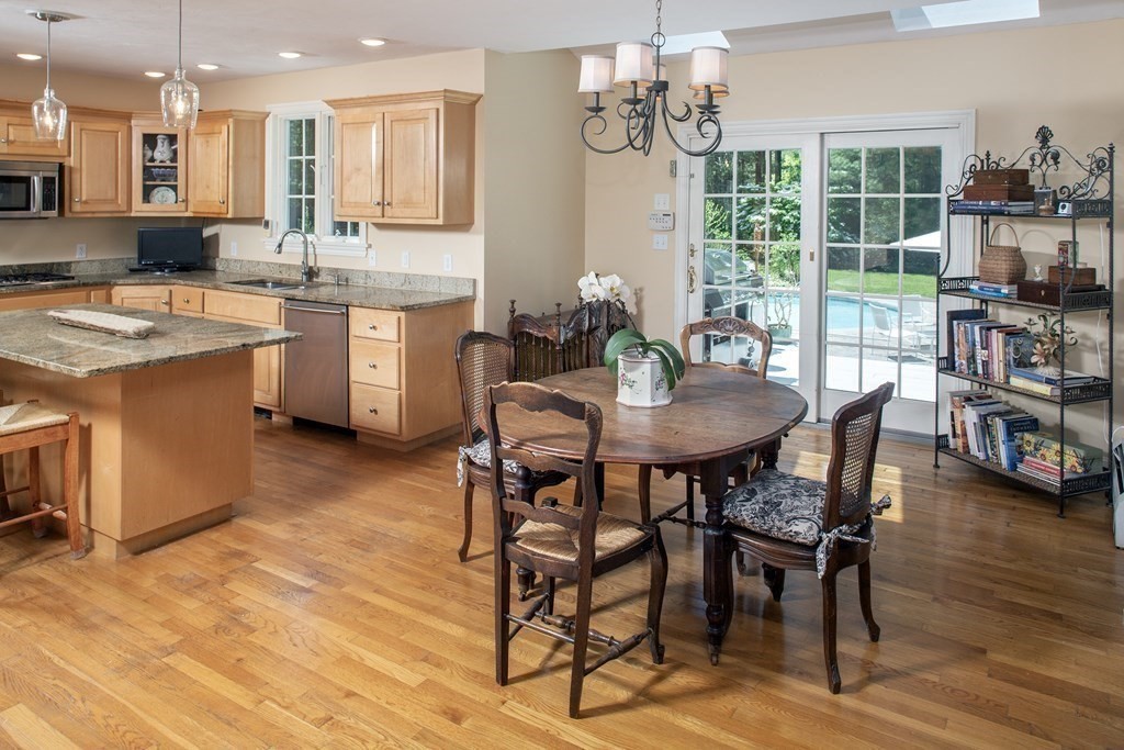 130 Union Bridge Road Duxbury, MA 02332 - Photo 8 of 33 a kitchen with stainless steel appliances kitchen island granite countertop a table chairs sink and cabinets