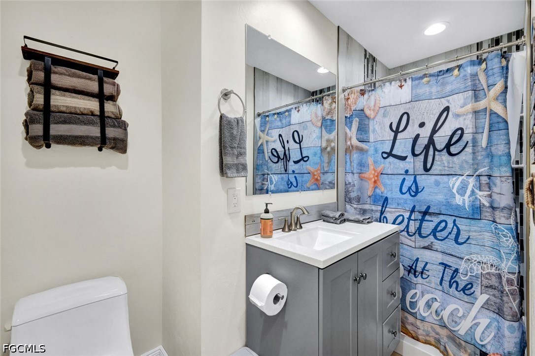 4830 Coquina Road Fort Myers Beach, FL 33931 - Photo 16 of 30 a bathroom with a sink and a mirror