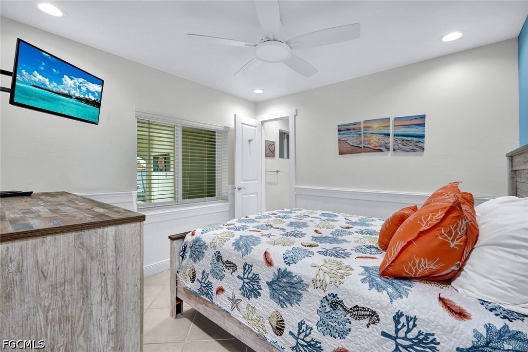 4830 Coquina Road Fort Myers Beach, FL 33931 - Photo 18 of 30 a bedroom with a bed and a window