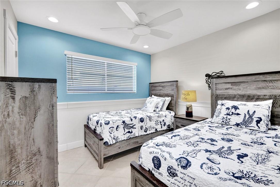 4830 Coquina Road Fort Myers Beach, FL 33931 - Photo 21 of 30 a bedroom with two beds and a window