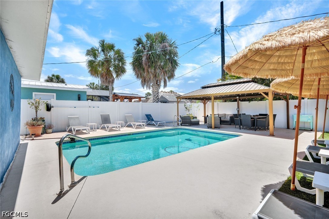 4830 Coquina Road Fort Myers Beach, FL 33931 - Photo 26 of 30 a view of swimming pool with outdoor seating and a patio