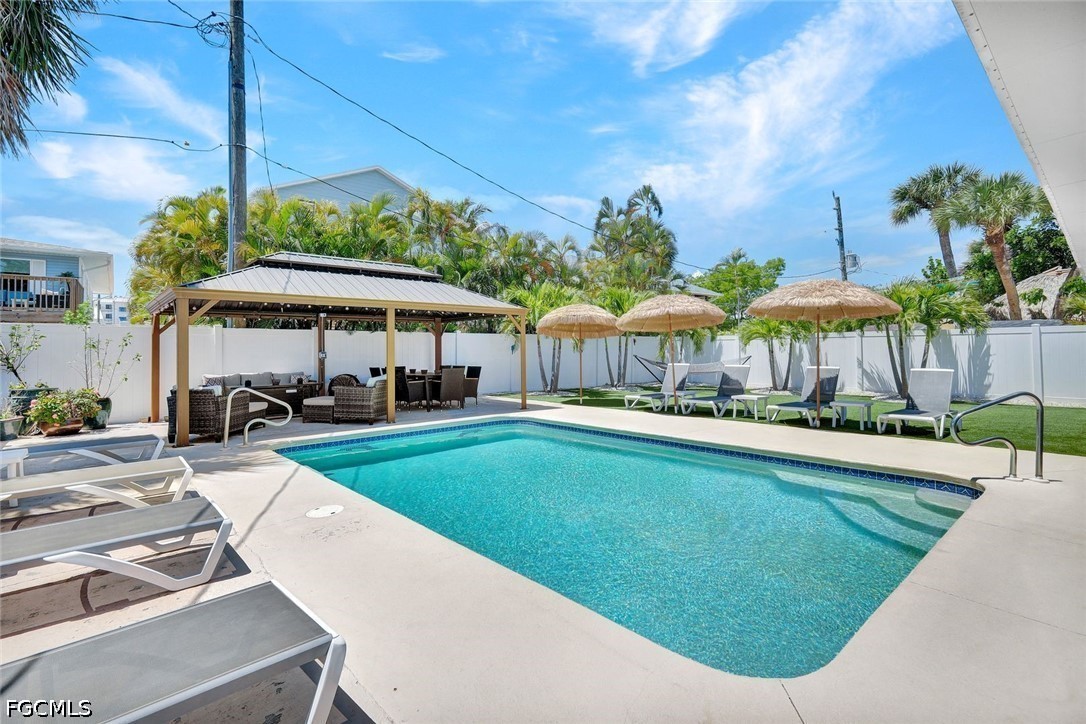 4830 Coquina Road Fort Myers Beach, FL 33931 - Photo 5 of 30 a swimming pool with outdoor seating yard and barbeque oven