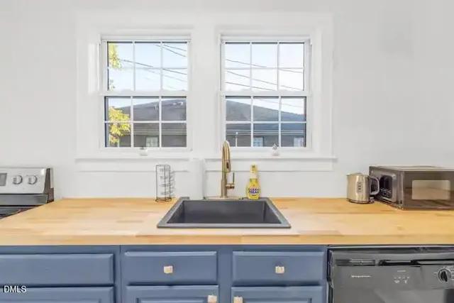 a kitchen with a sink and large window