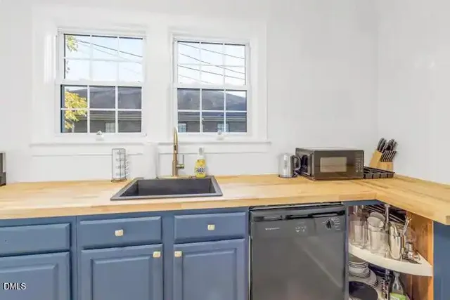 a kitchen with a sink and cabinets