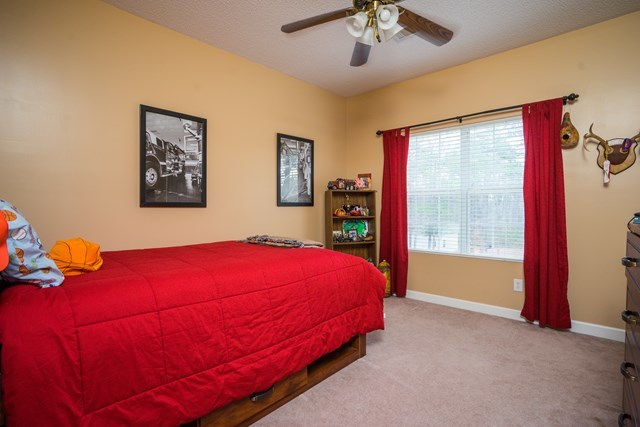 1267 Johnson Road Macon, GA 31220 - Photo 12 of 20 a bed sitting in a bedroom next to a window