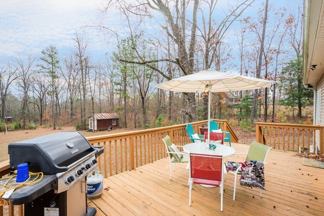 1267 Johnson Road Macon, GA 31220 - Photo 17 of 20 a view of a patio with couches table and chairs under an umbrella with wooden floor
