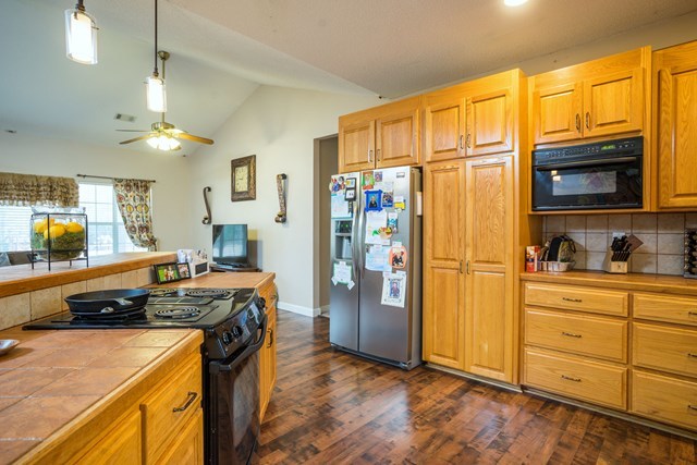 1267 Johnson Road Macon, GA 31220 - Photo 5 of 20 a kitchen with stainless steel appliances granite countertop a stove refrigerator and cabinets