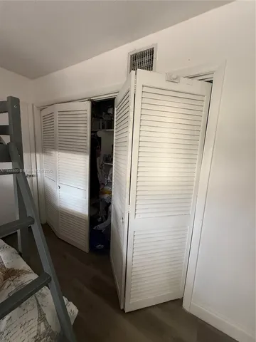 a bedroom with a bed and flat screen tv