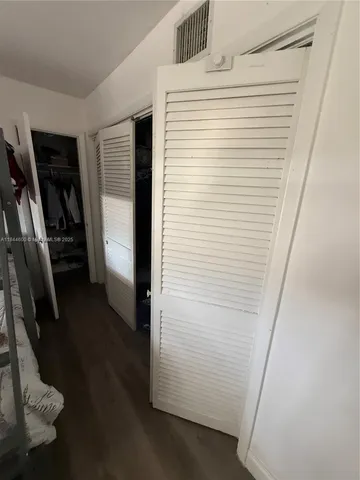 a view of storage and utility room with racks on the wall