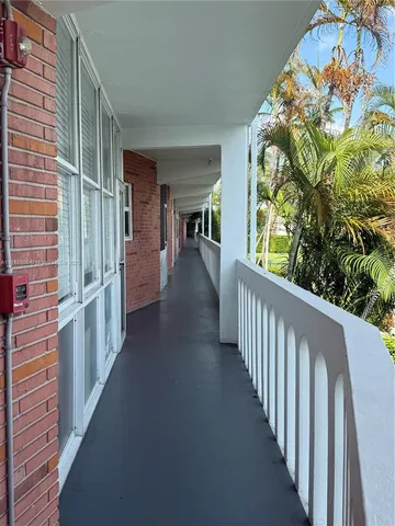 a view of a patio with table and chairs with wooden floor and fence