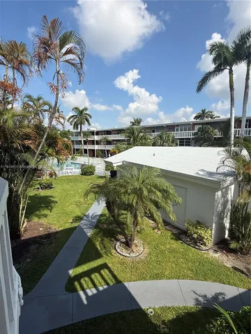 a view of a garden with a building in the background