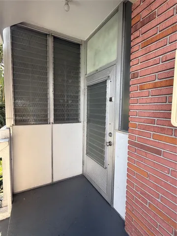 a view of a door and a window