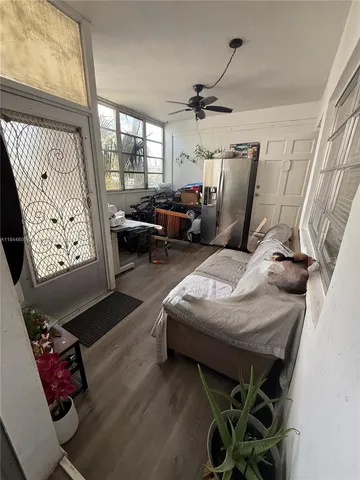 a living room with furniture and a mirror