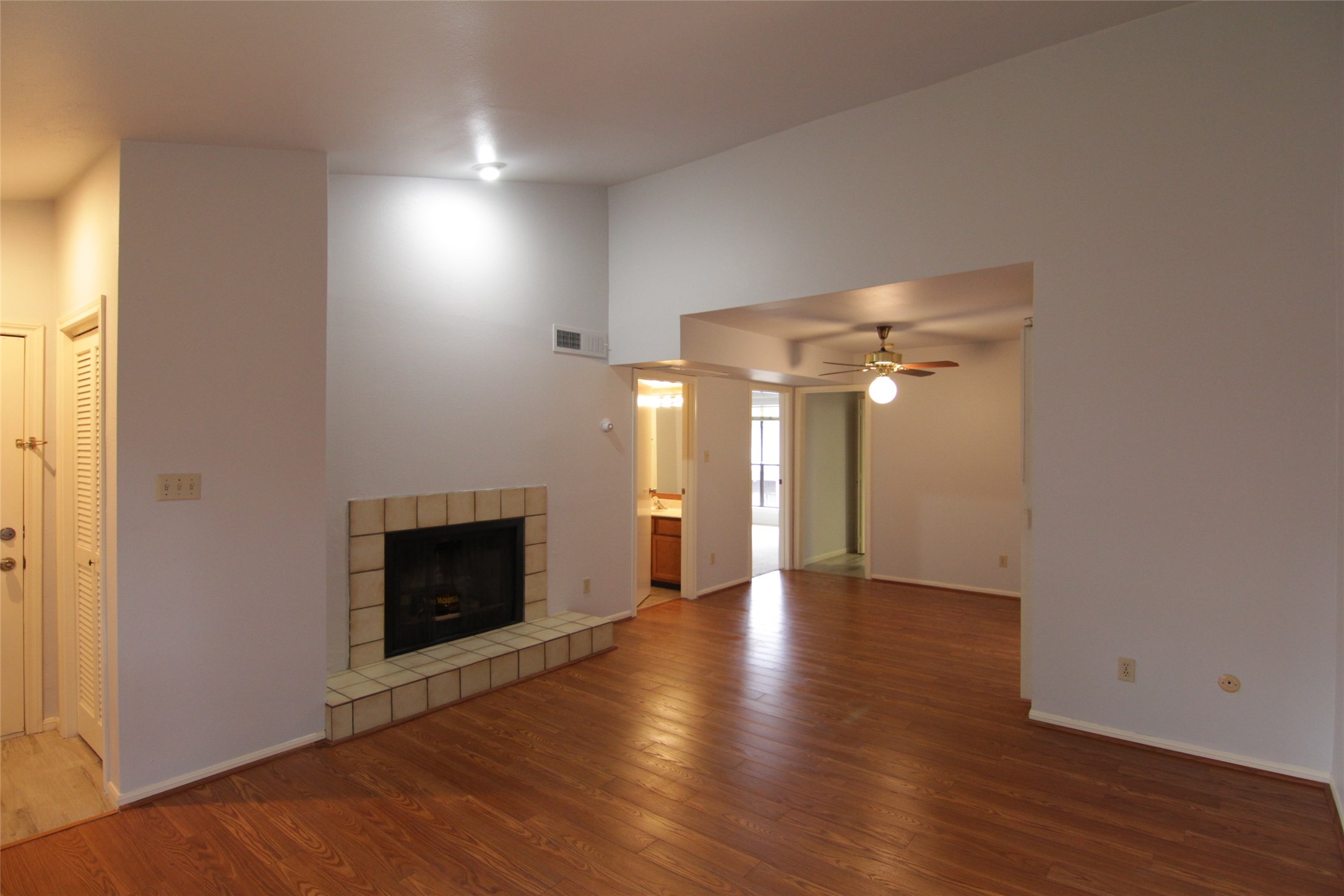 3100 Walnut Bend Lane, Unit 118 Houston, TX 77042 - Photo 3 of 20 an empty room with wooden floor fireplace and windows