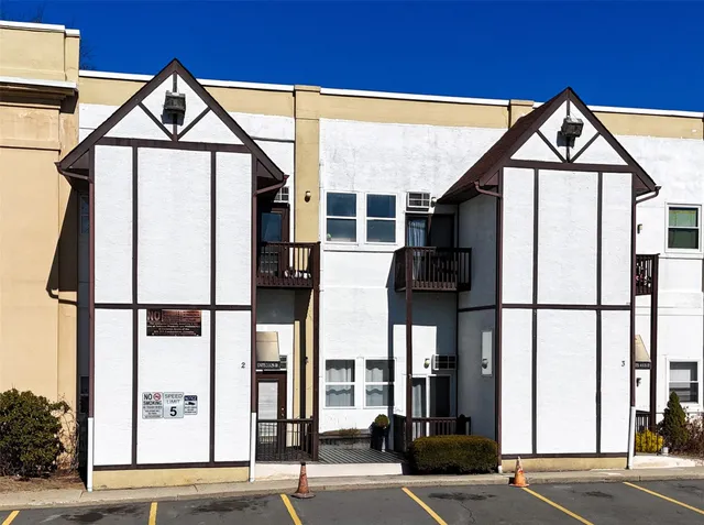 a front view of a building with glass windows and door