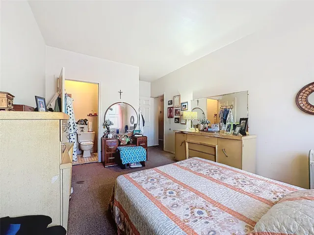 a bedroom with a bed and a dresser in it