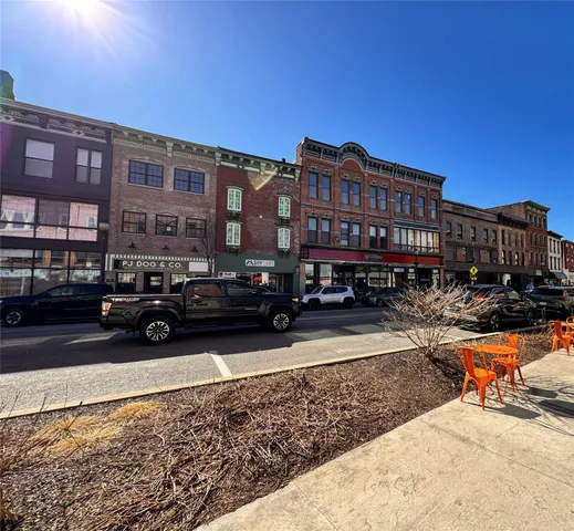 a view of a cars park in front of a building