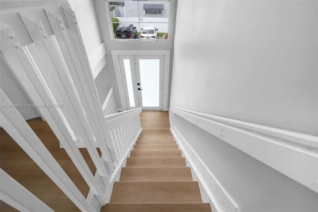 a view of entryway and hall with wooden floor