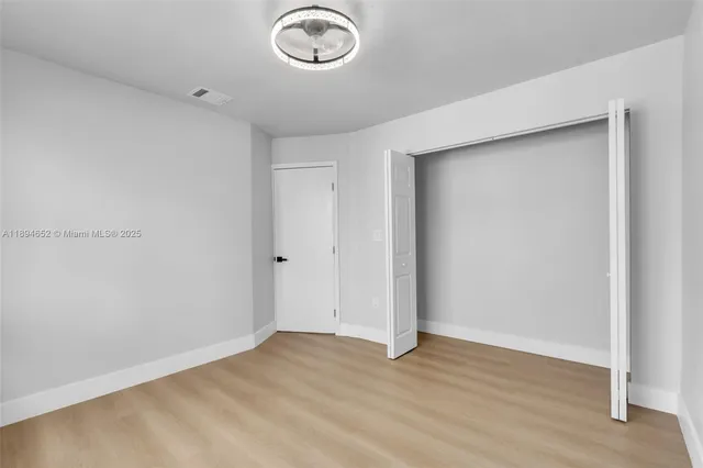 an empty room with wooden floor
