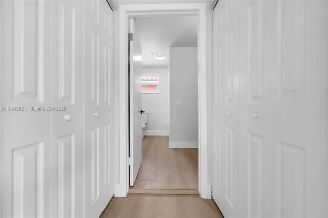 a view of a bathroom from a hallway
